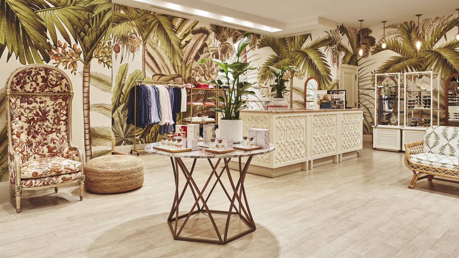 A brightly lit store with light wood features and clothes on shelves and hangers.