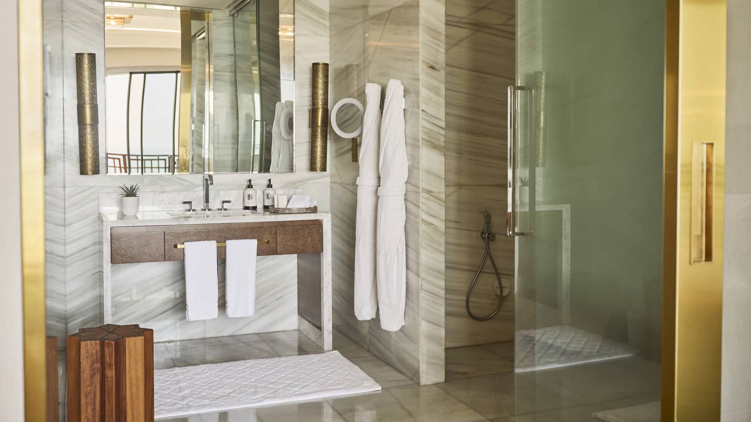 Hotel room bathroom with mobility-accessible glass shower