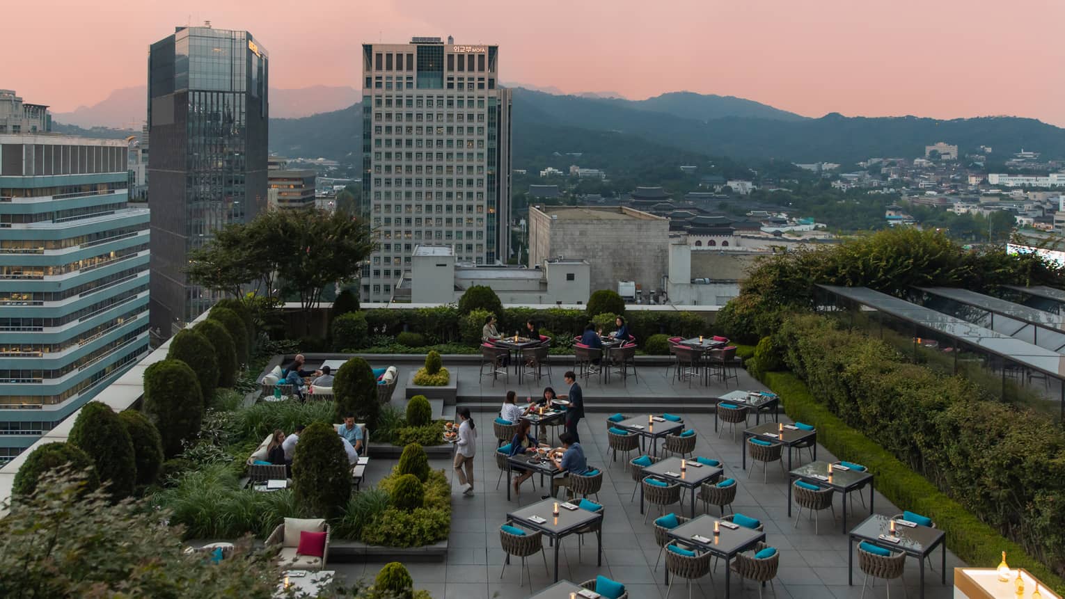 A terrace overlooking a city and mountains.