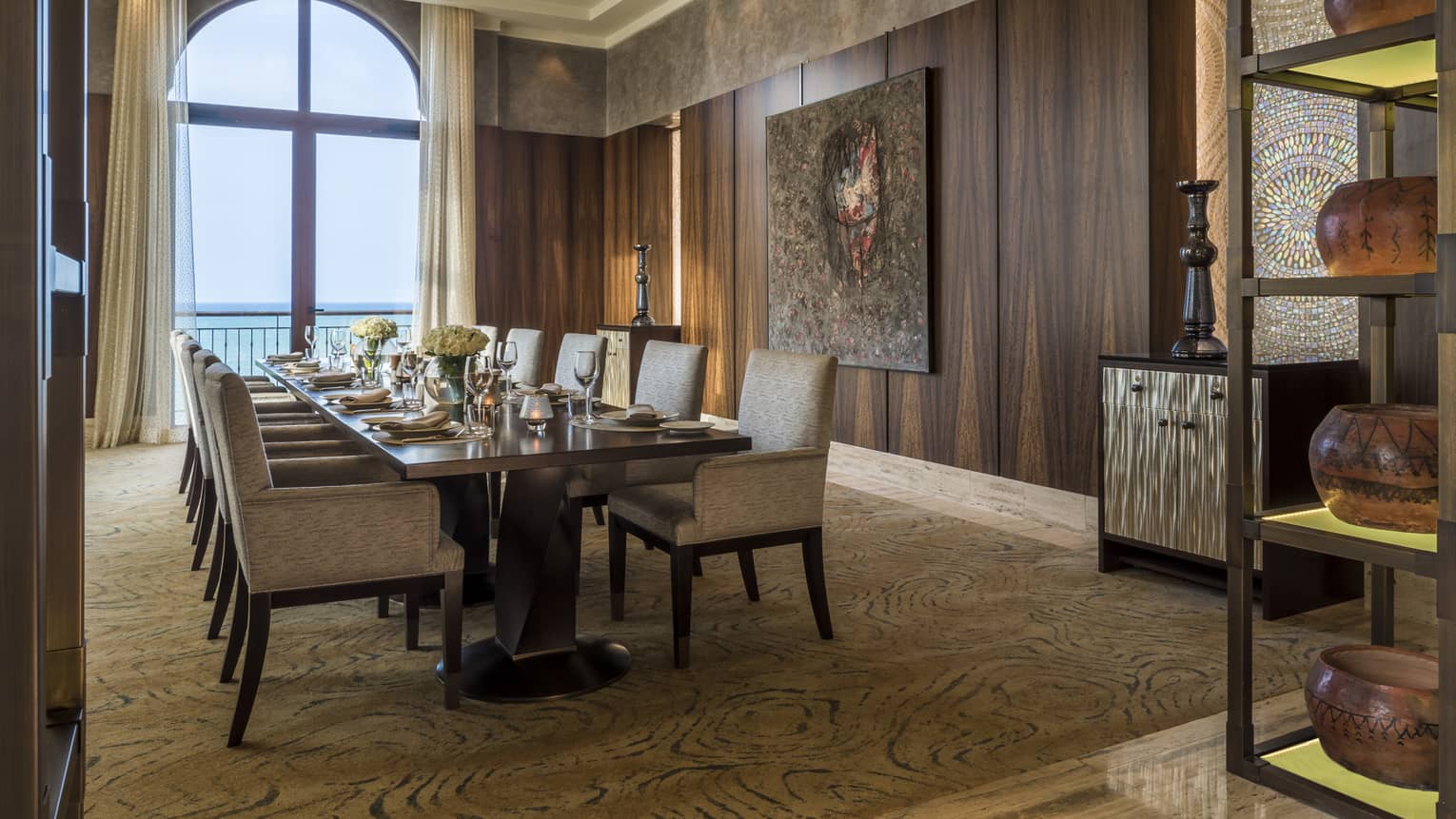 Long dining table in private Creek Bistro dining room, wood paneled walls, view of ocean