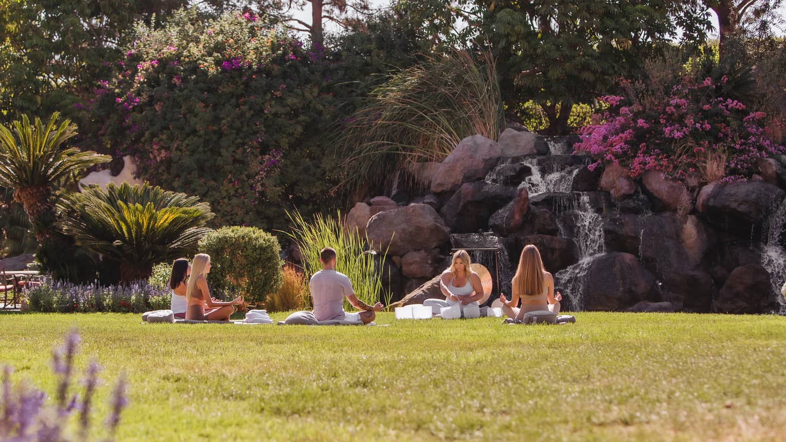 A group sound healing class in an outdoor garden