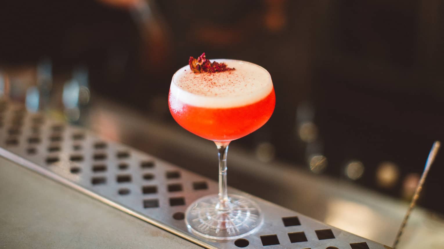 A blood orange martini with a red topping. 
