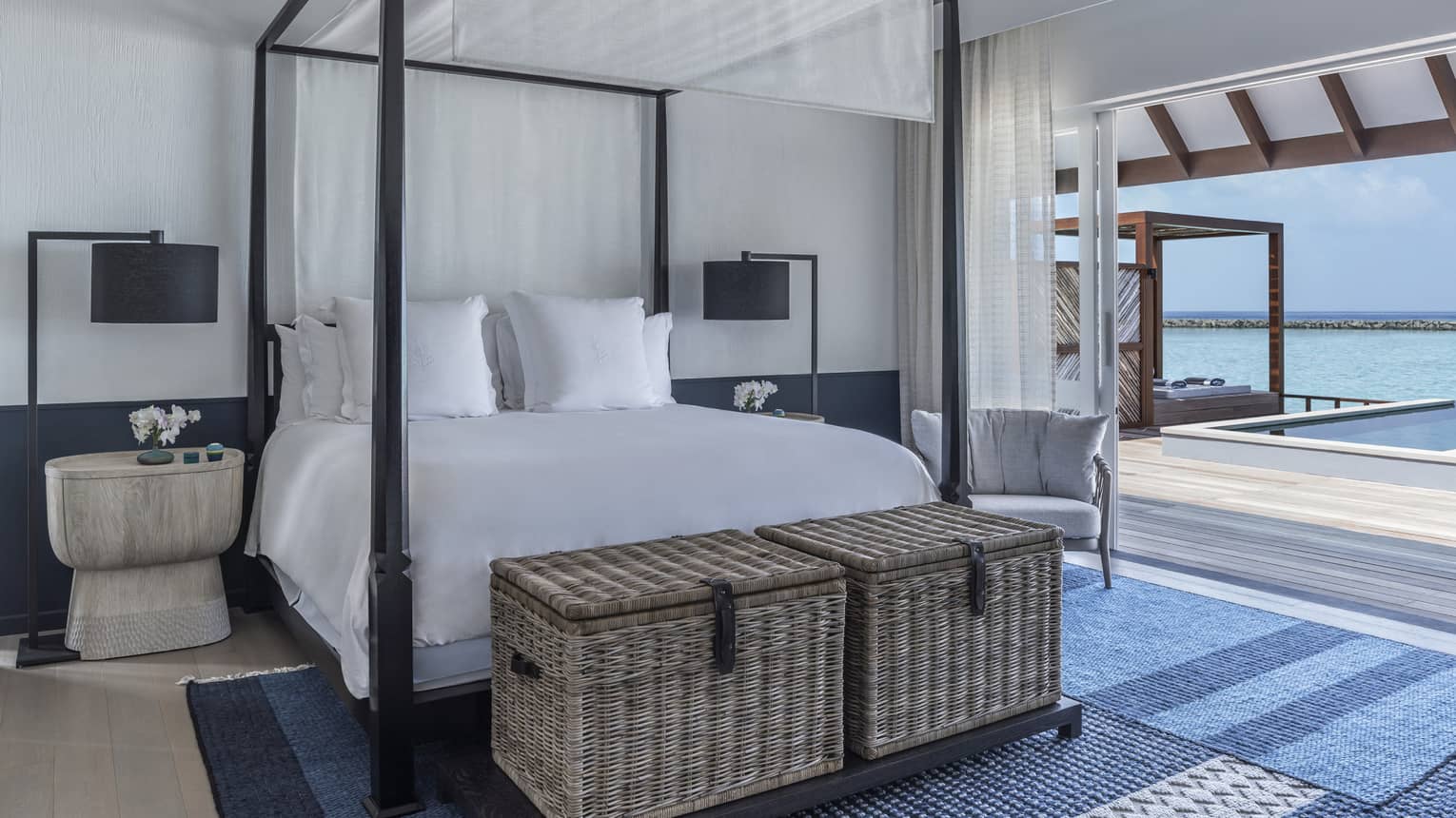 Sunrise Water Villa with Pool bedroom with four-poster bed, doorway opening onto deck with pool
