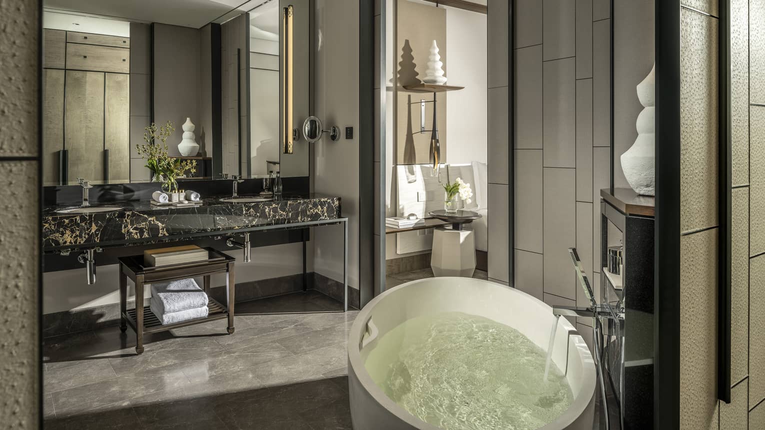 Guest bathroom, large mirror, standalone white tub, opening to bedroom