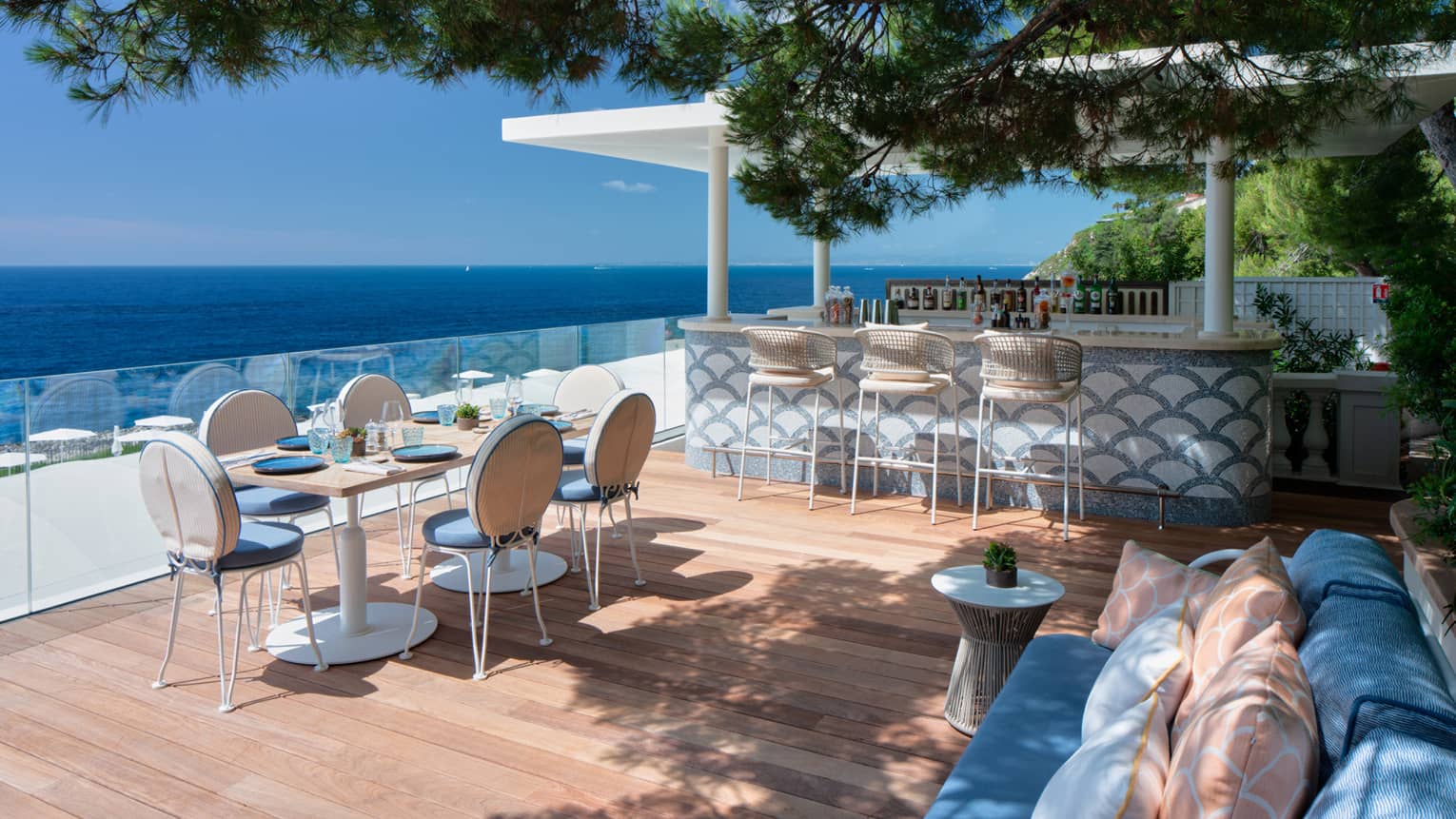 Pool-side bar and seating area with sea view