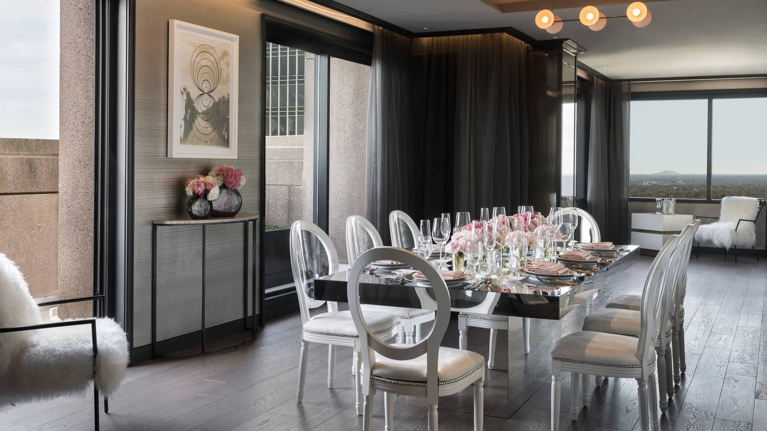 Bright, modern Penthouse boardroom private dining table under bulb lights