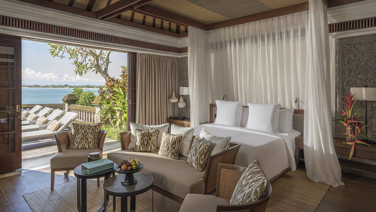 Royal Villa bedroom with canopy bed, doorway to pool and lounge area