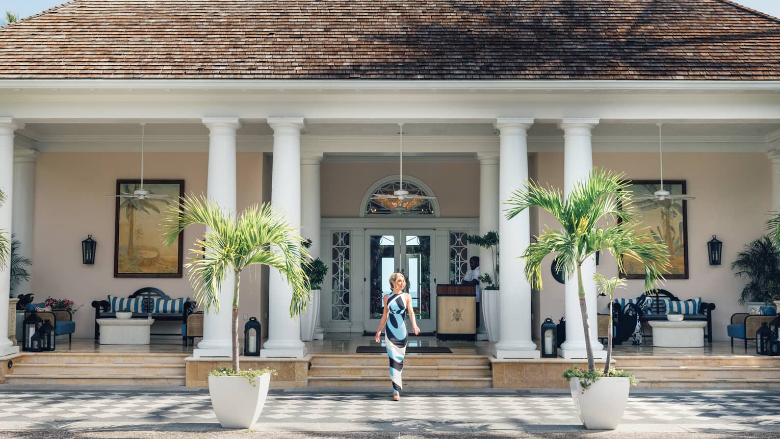 A person wearing a dress and walking down the steps outside of a building