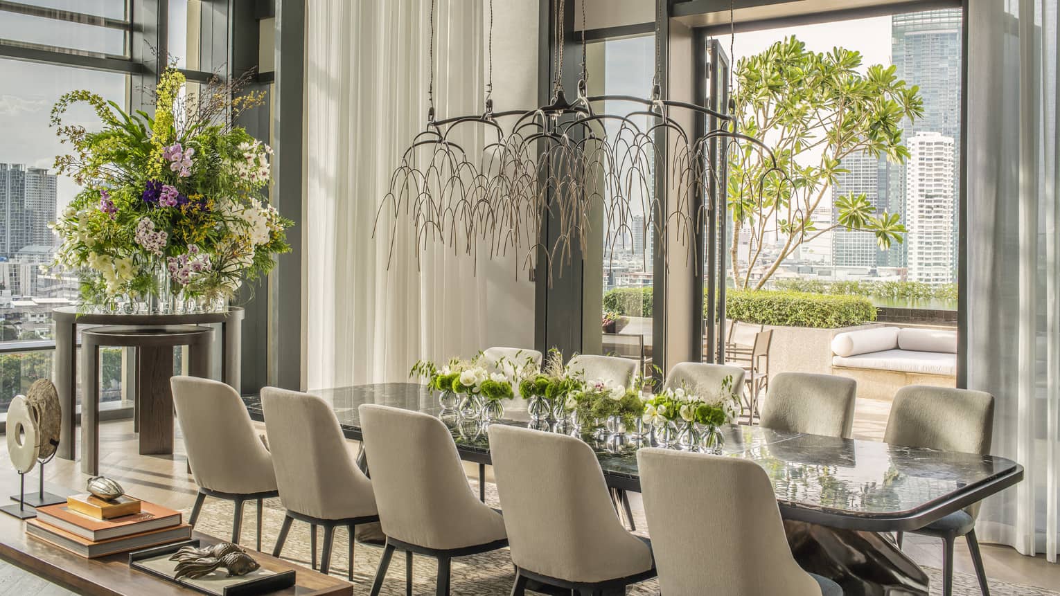 Dining table with 10 chairs, opening to a city-view terrace