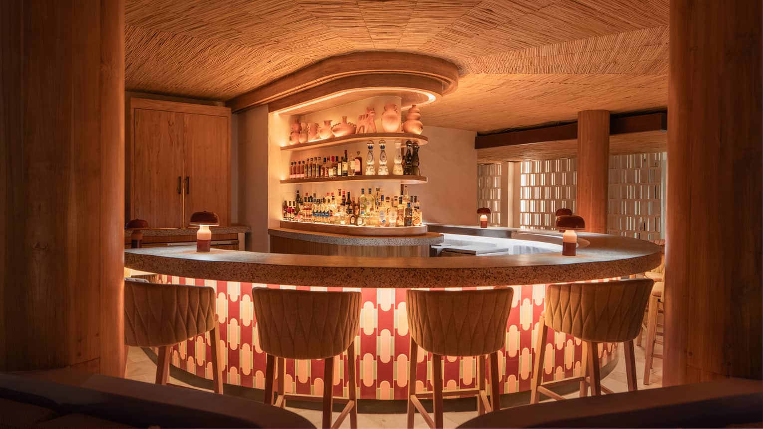 Curved bar counter lit up with under-the-counter lighting
