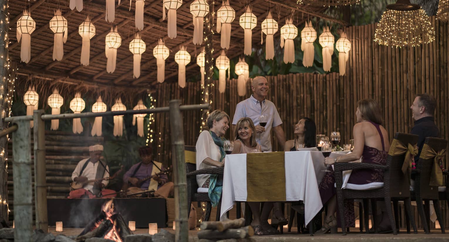 Elephant Camp Dinner, smiling group of diners unders rows of paper lanterns