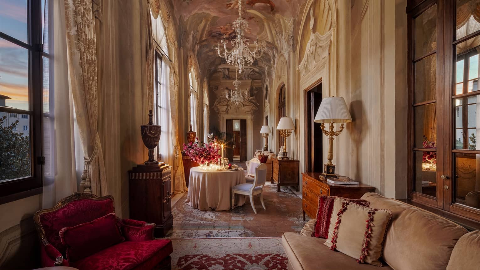 Elegant historic salon with rich fabrics and arched frescoes