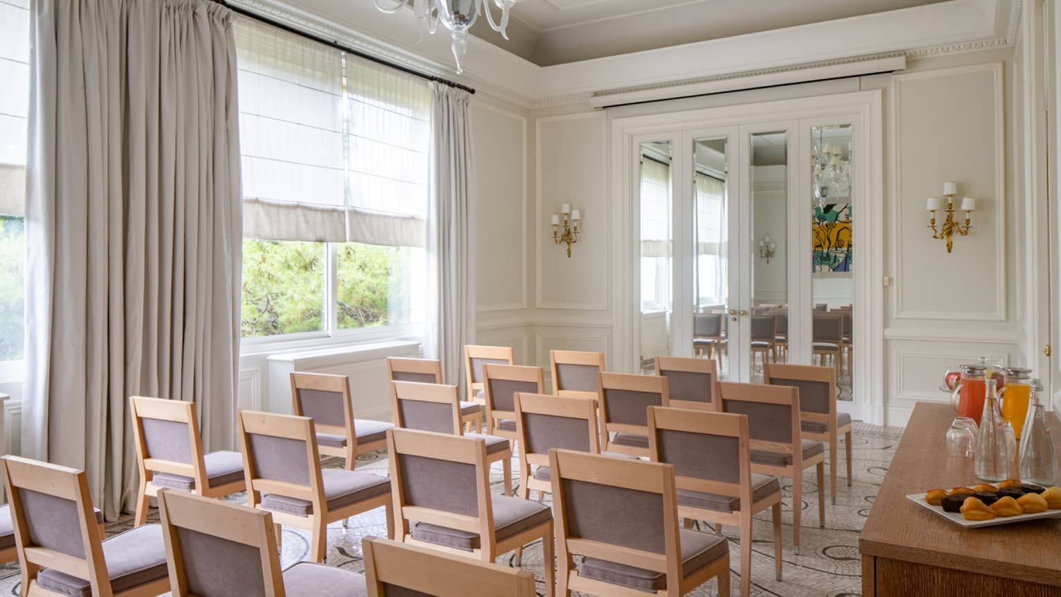 Salon Les Pins with classroom seating, curtained window, chandelier, French doors