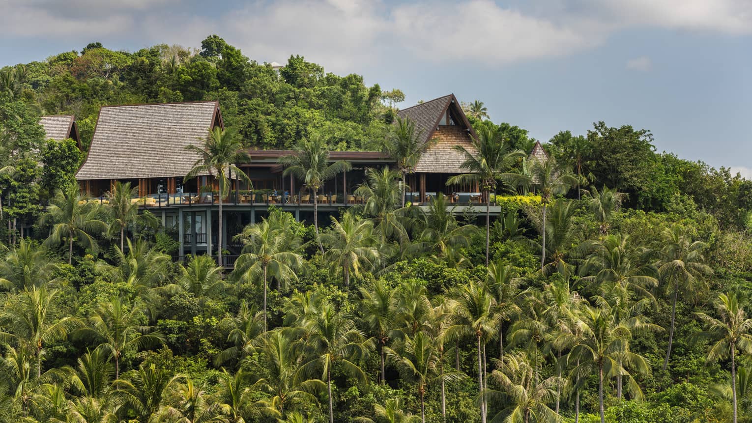 Exterior view of KOH Thai Kitchen and Bar building, perched on mountain amid tropical trees