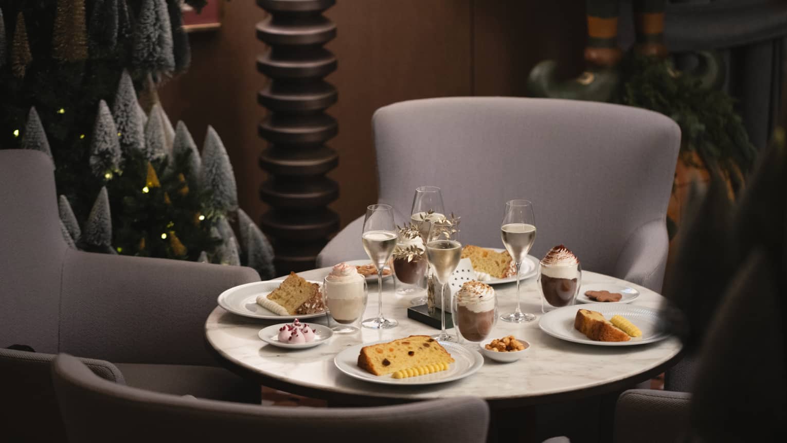 A dining table set with festive food items and beverages