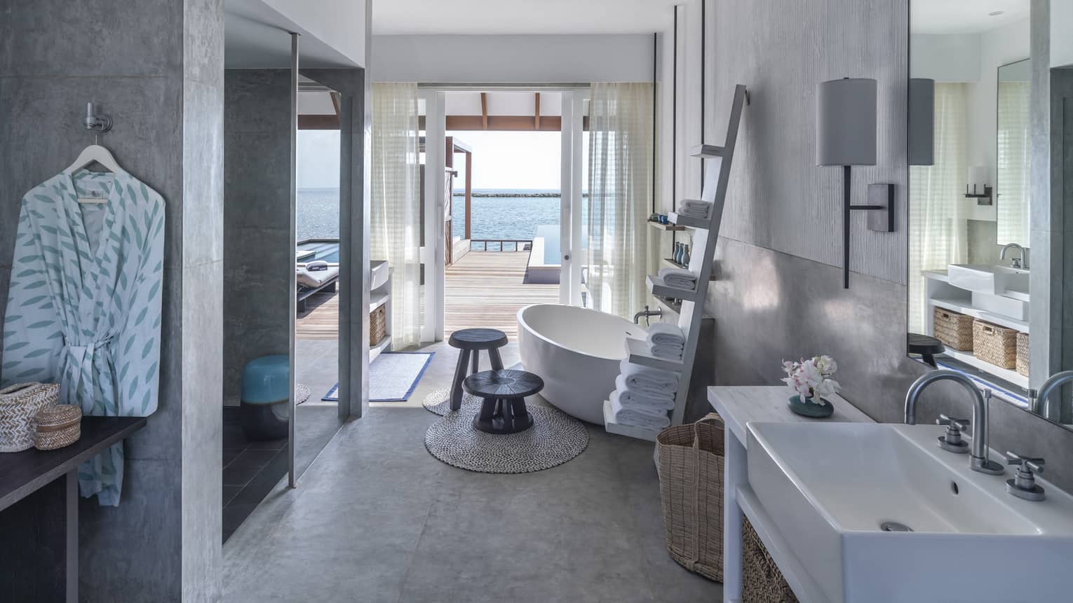 Sunrise Water Villa with Pool bathroom, large soaking tub, towel rack, doorway to deck with pool