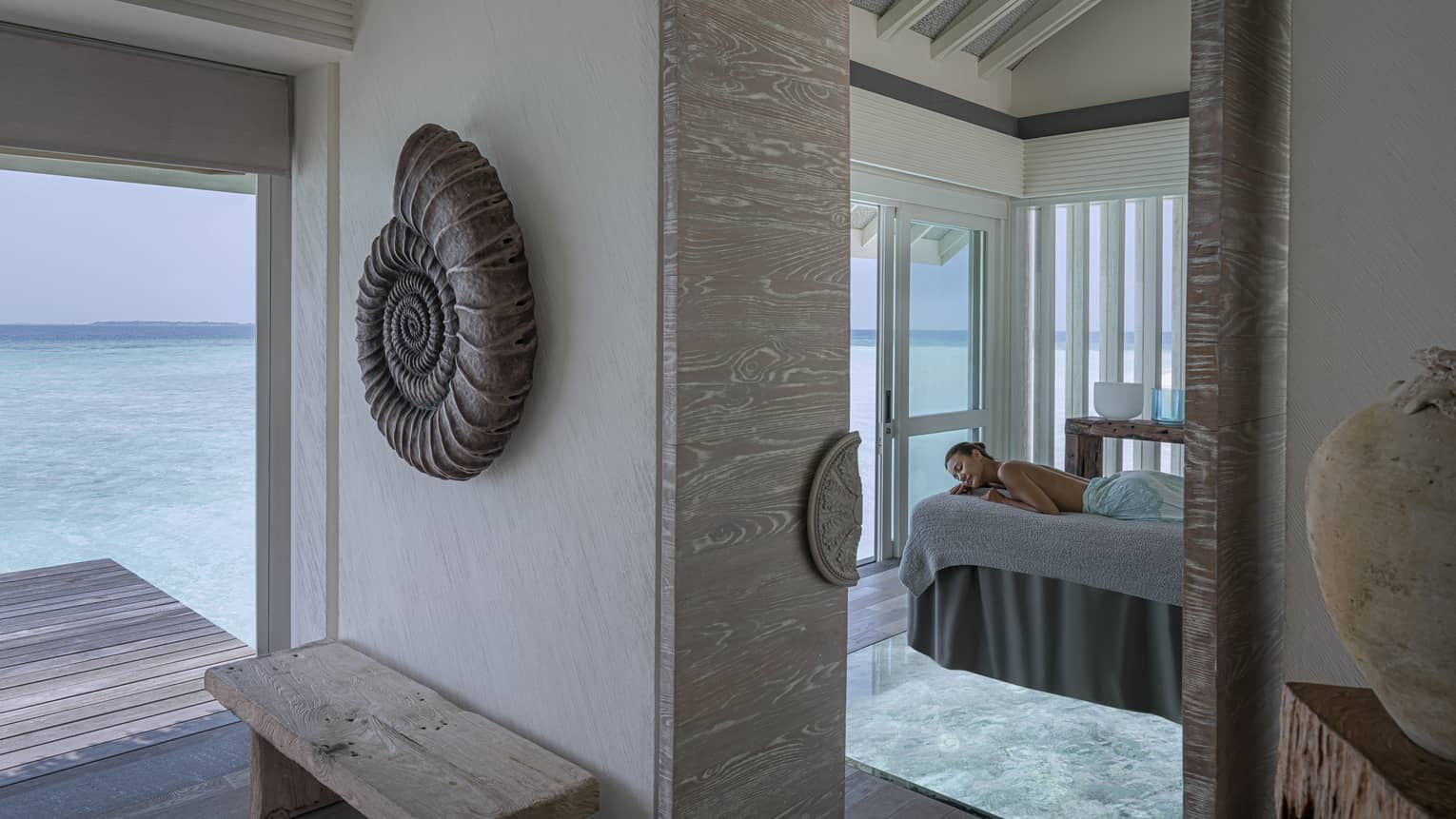 Woman on massage table overlooking the ocean at the Spa