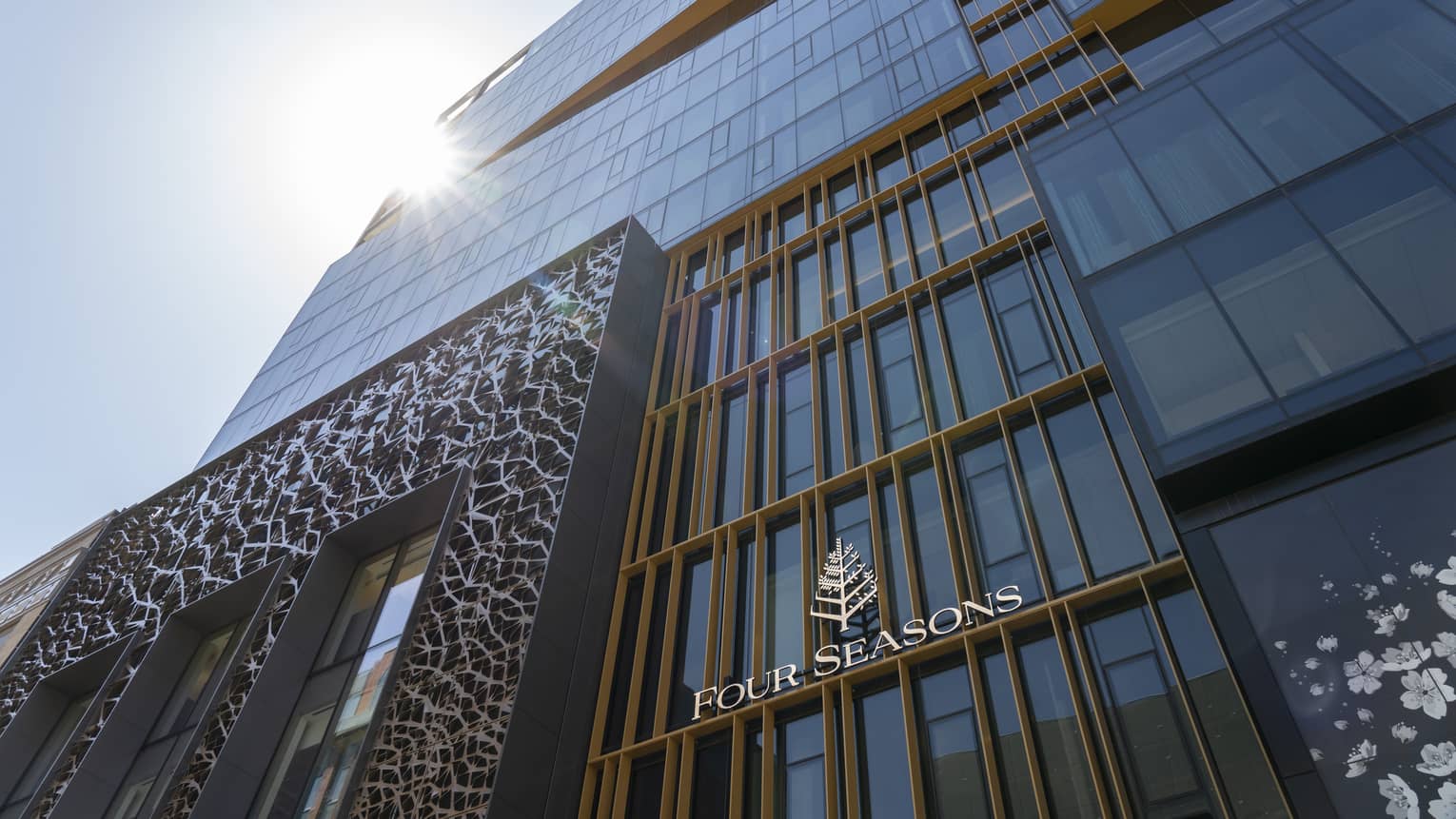 A front view of the Four Seasons Montreal hotel, featuring the Art Deco design above the entrance. 