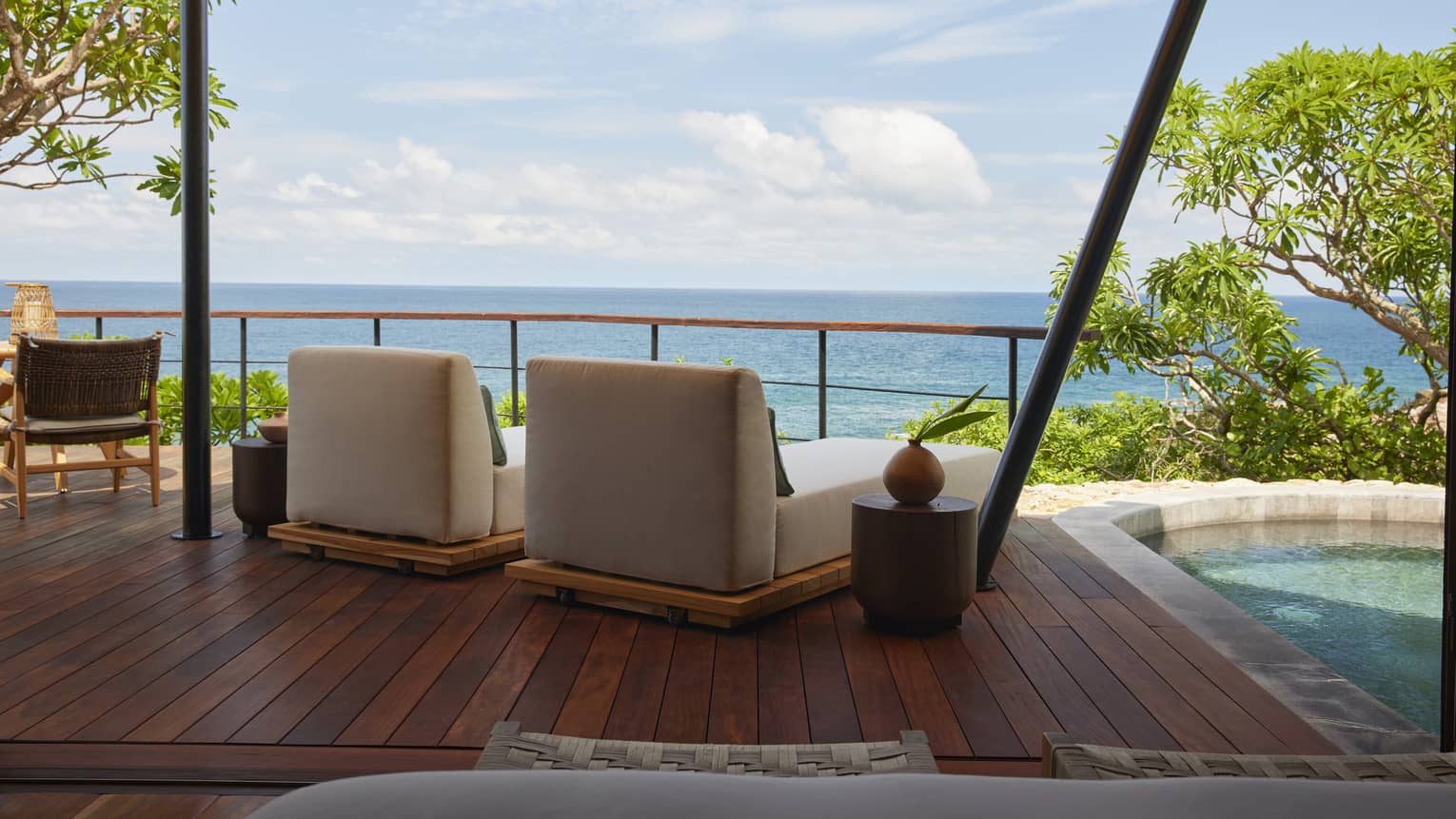 Shaded deck of luxury tent overlooking the ocean, with private plunge pool and two lounge chairs