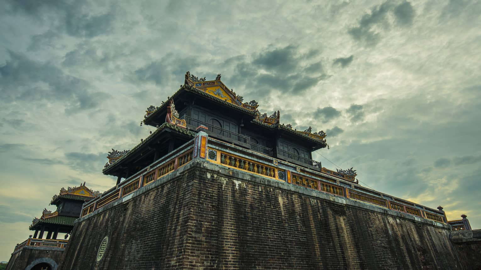A ground view looking up the side of an ornate building in Hue City, Imperial City