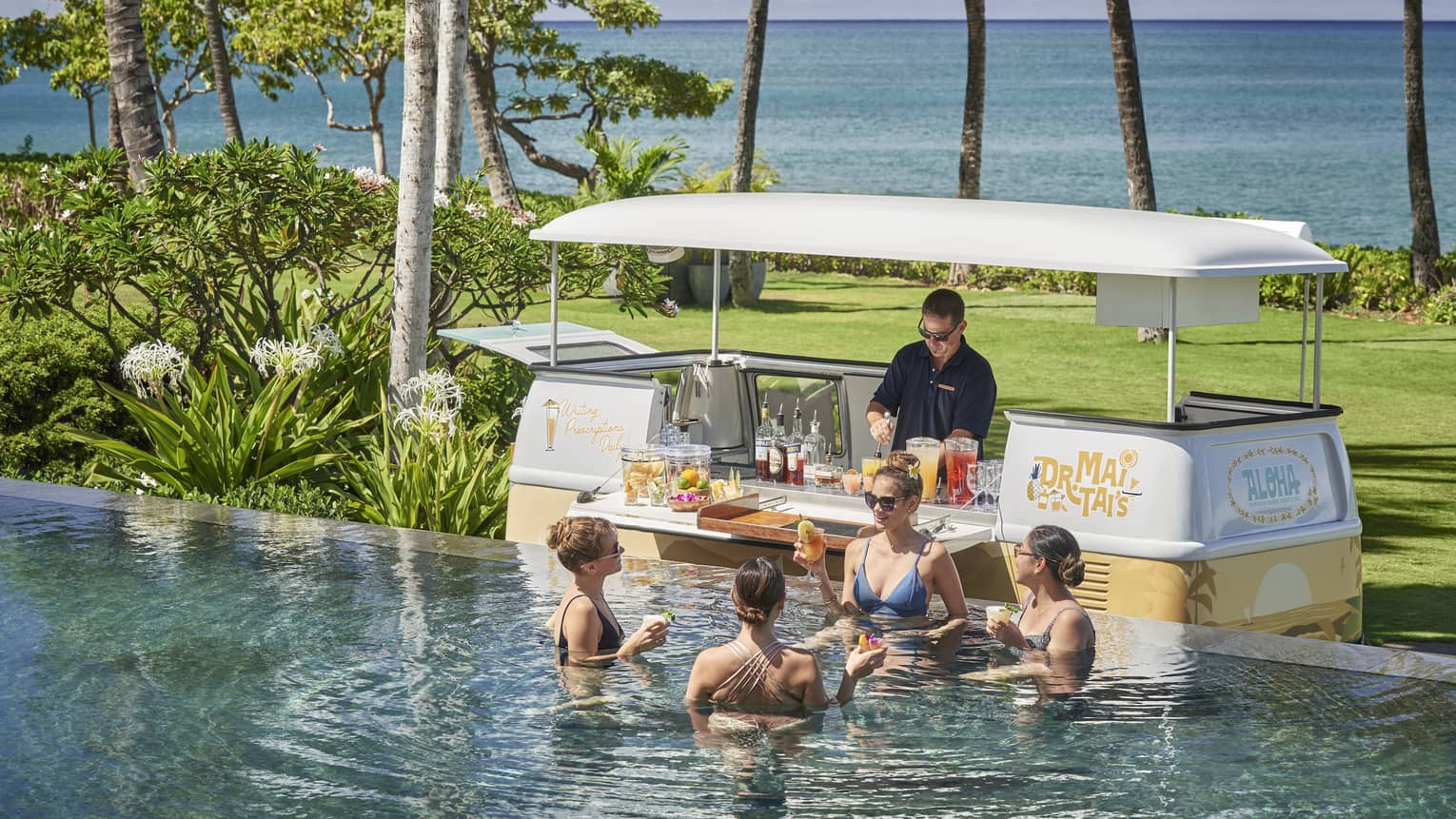 Male bartender in swim-up pool bar cart in tropical location
