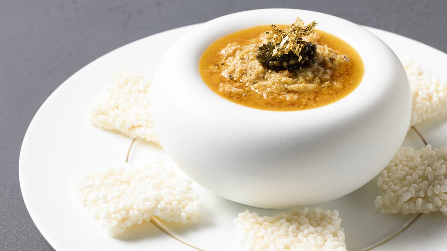 Scorched Rice with Crab on a modern white plate