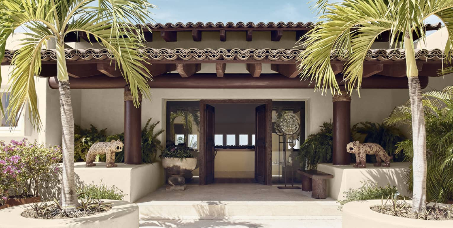 Entrance to private villa with palm trees