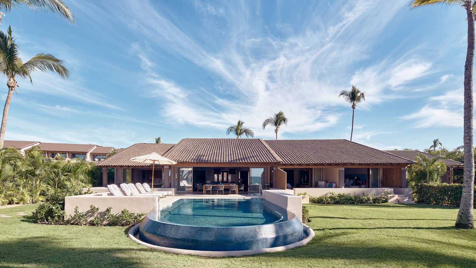 Arena Beach House exterior with front pool