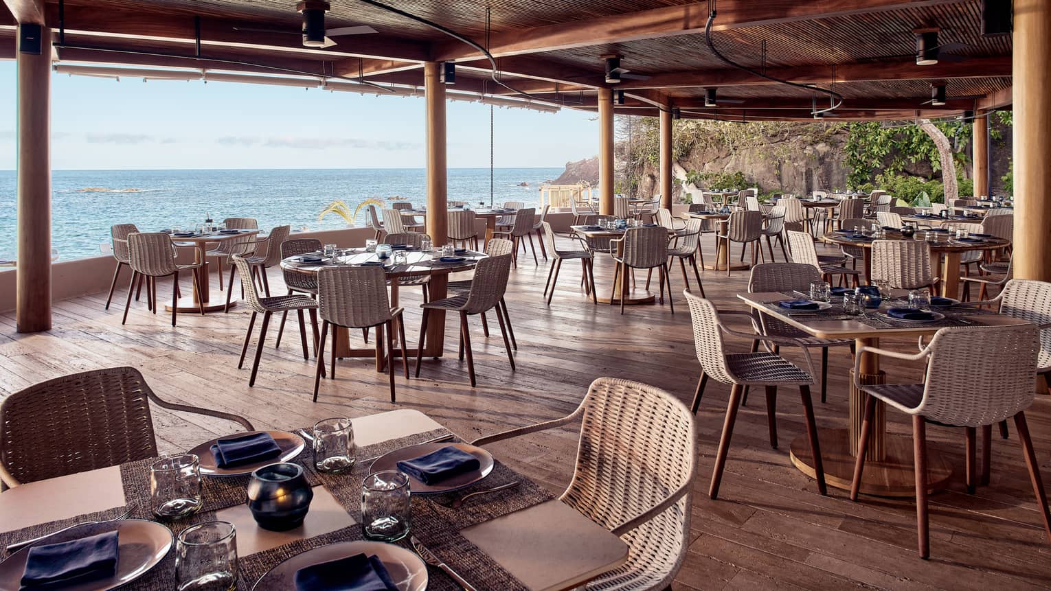 Dining tables next to an open view of the ocean.