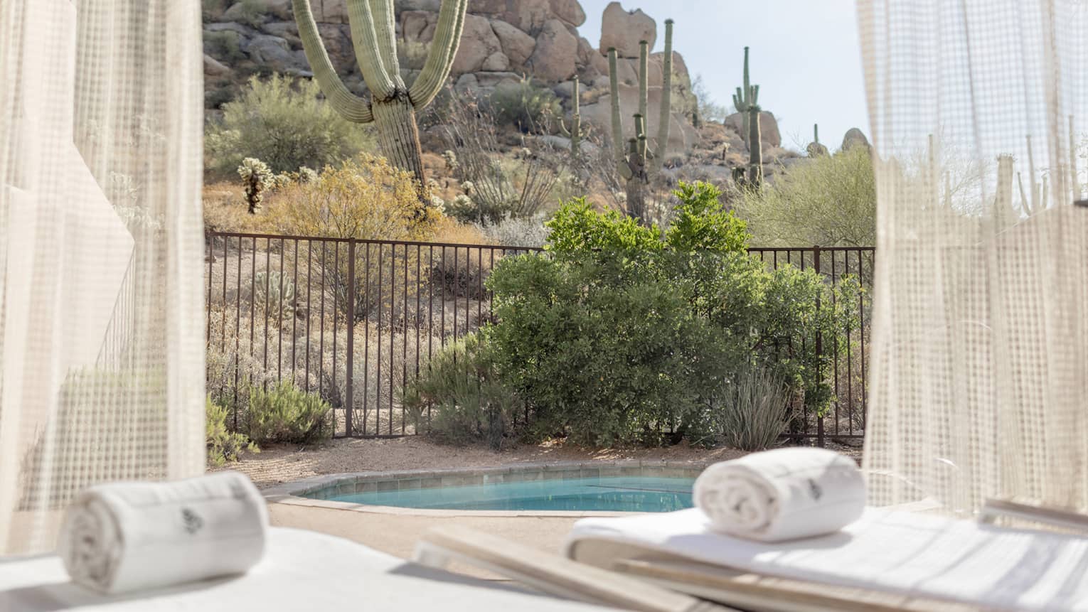A plunge pool and lounge chairs outside.