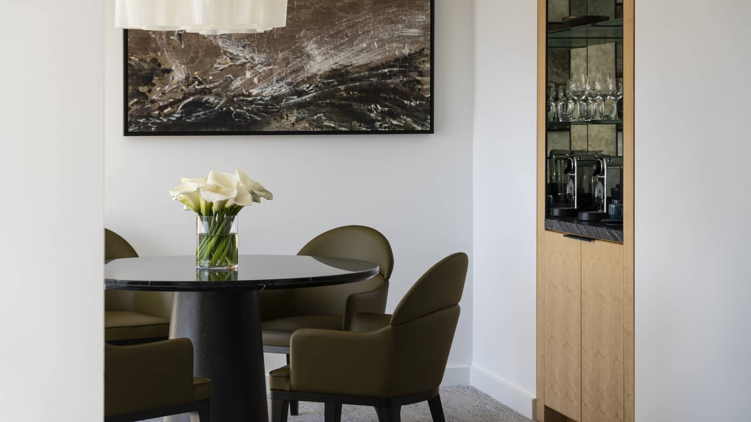 The Deluxe Elliot Bay Suite has a mini dining room and kitchenette with a coffee machine