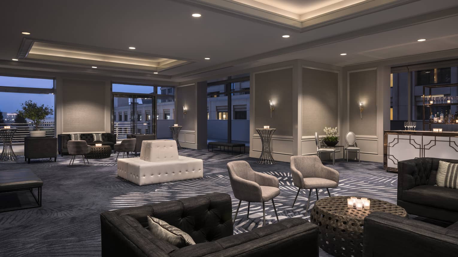 Veranda Ballroom cocktail reception at night with sofas, plush armchairs 