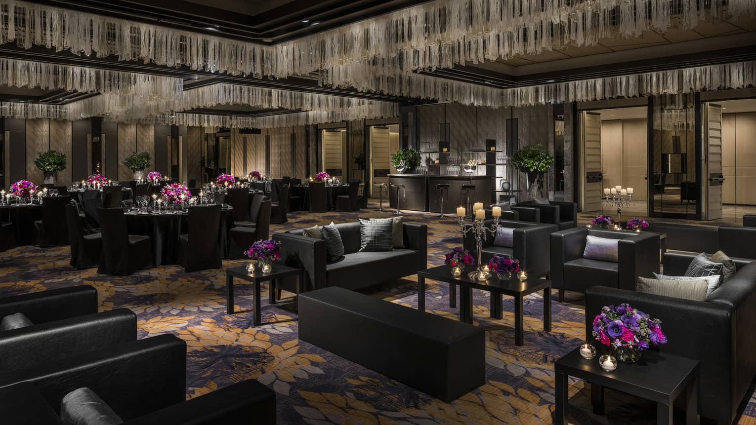 Modern Nuri Ballroom with black furniture, black dining tables, bright flowers and candles