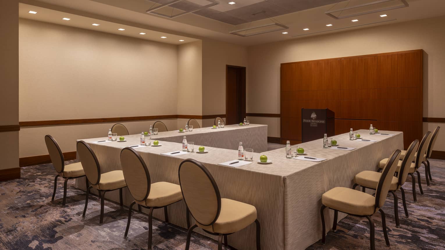 A meeting room with a u-shaped table.
