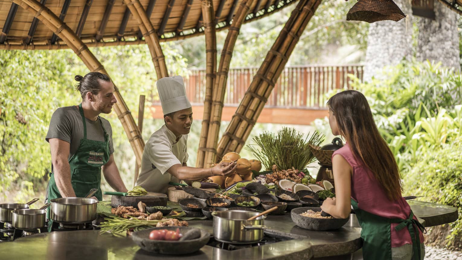 Four Seasons chef instructs a couple at the Sokasi Cooking School