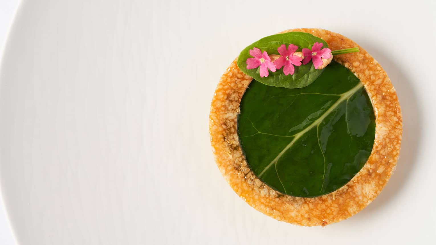  Tourta de Blea pastry with vanilla olive oil and garnish of young shoots 
