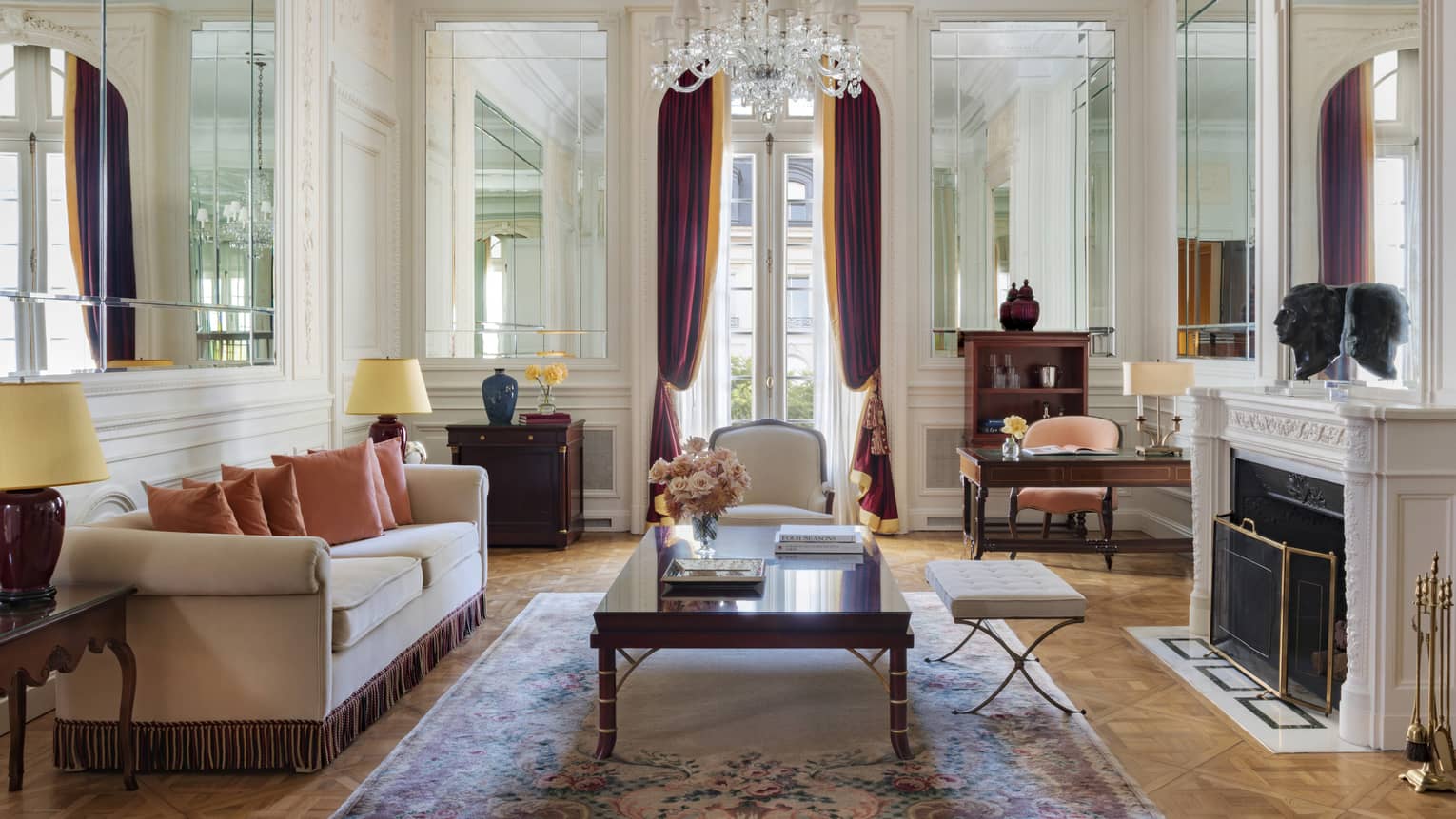 Elegant hotel Royal Suite living room, with crystal chandelier, sofa and fireplace