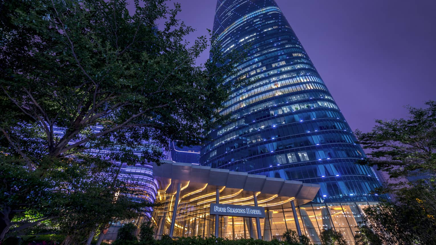 Four Seasons Hotel Guangzhou at night, high rise building with blue lights