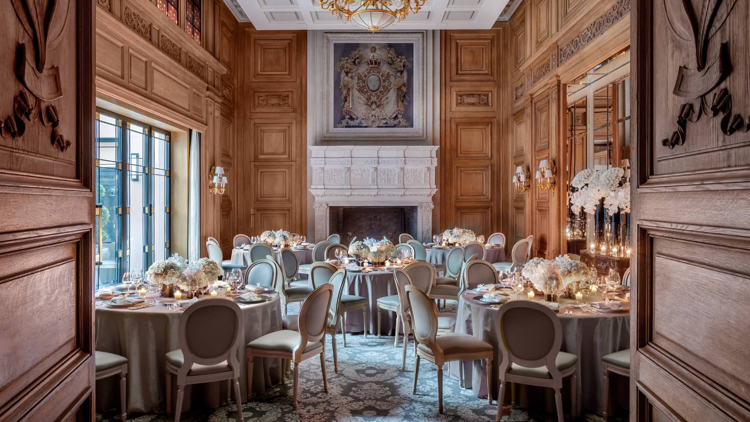 Salon Louis XIII room banquet, elegant carved wood doors, walls and ceiling, painting over mantle 