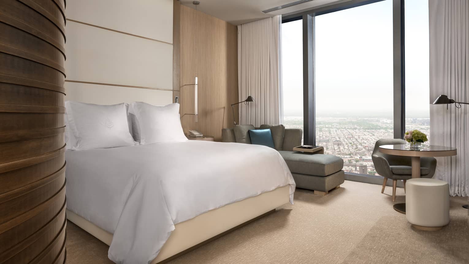 Four Seasons Hotel Philadelphia at Comcast Center curved modern wood wall, bed, chaise, cafe table, window