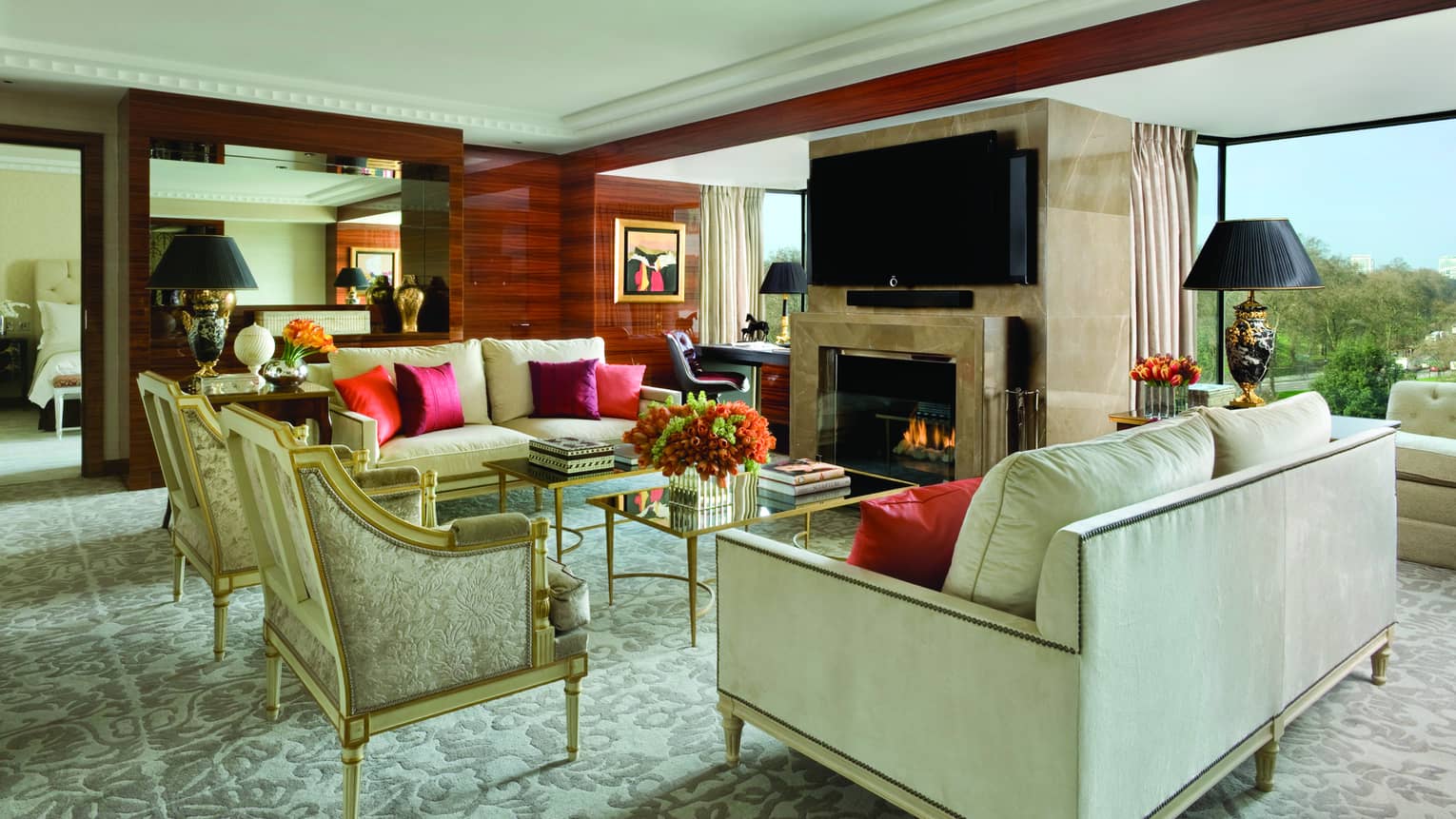 Presidential Suite elegant white sofas, armchairs by marble fireplace, desk, windows