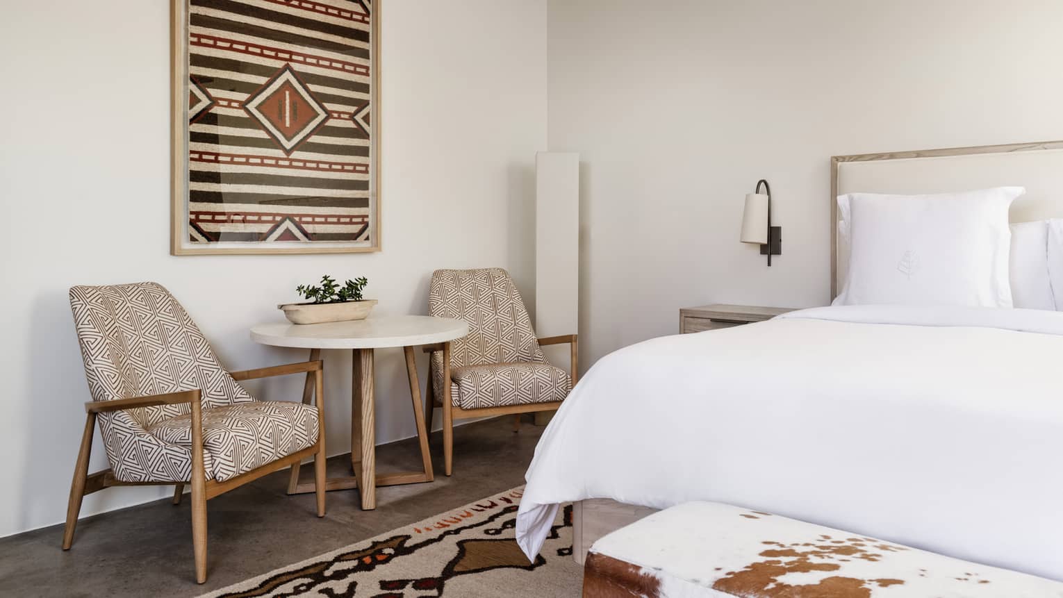 Hotel room with king bed, round table and two chairs at Four Seasons Resort Santa Fe