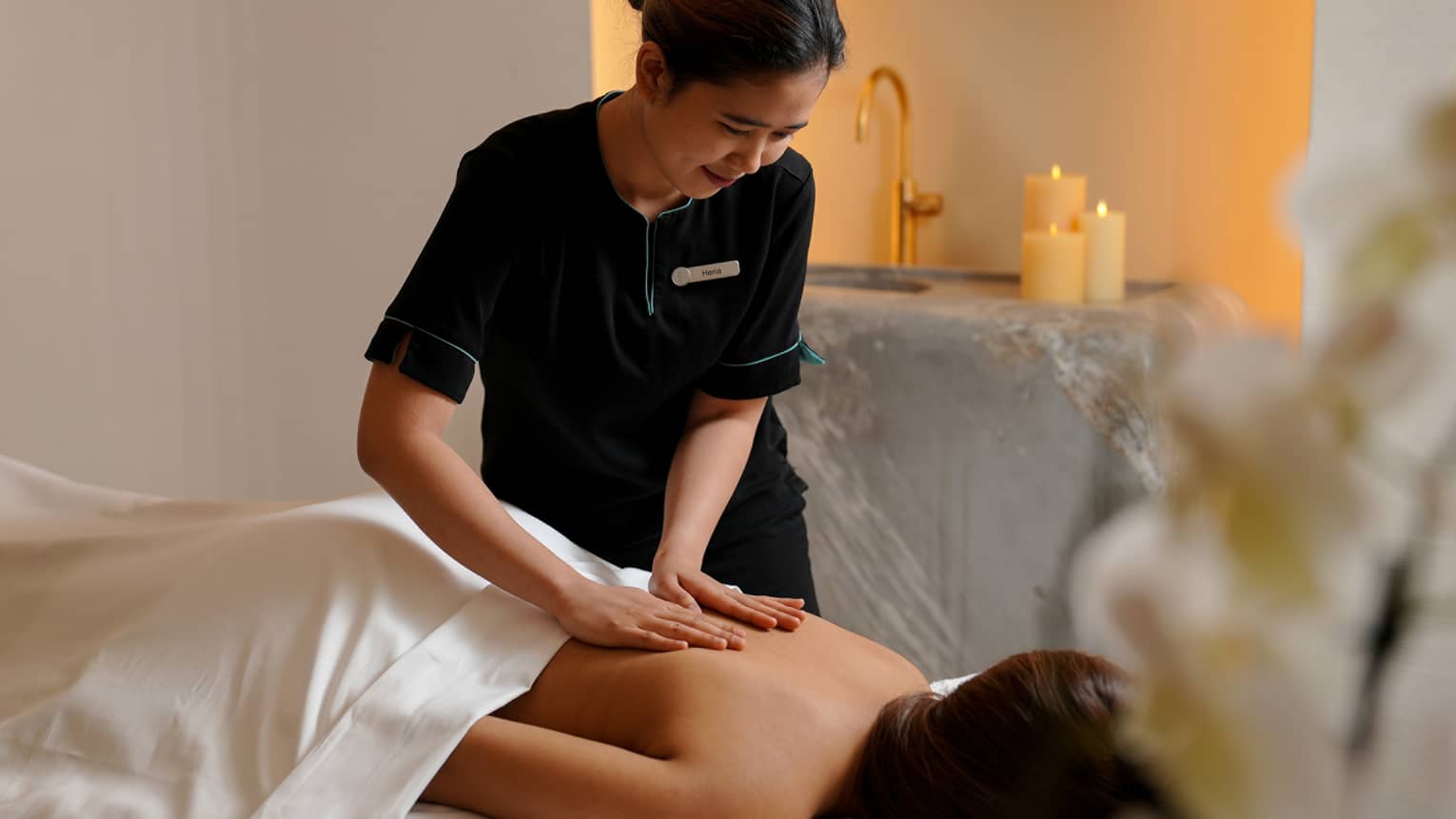A woman receiving a massage treatment in a spa.