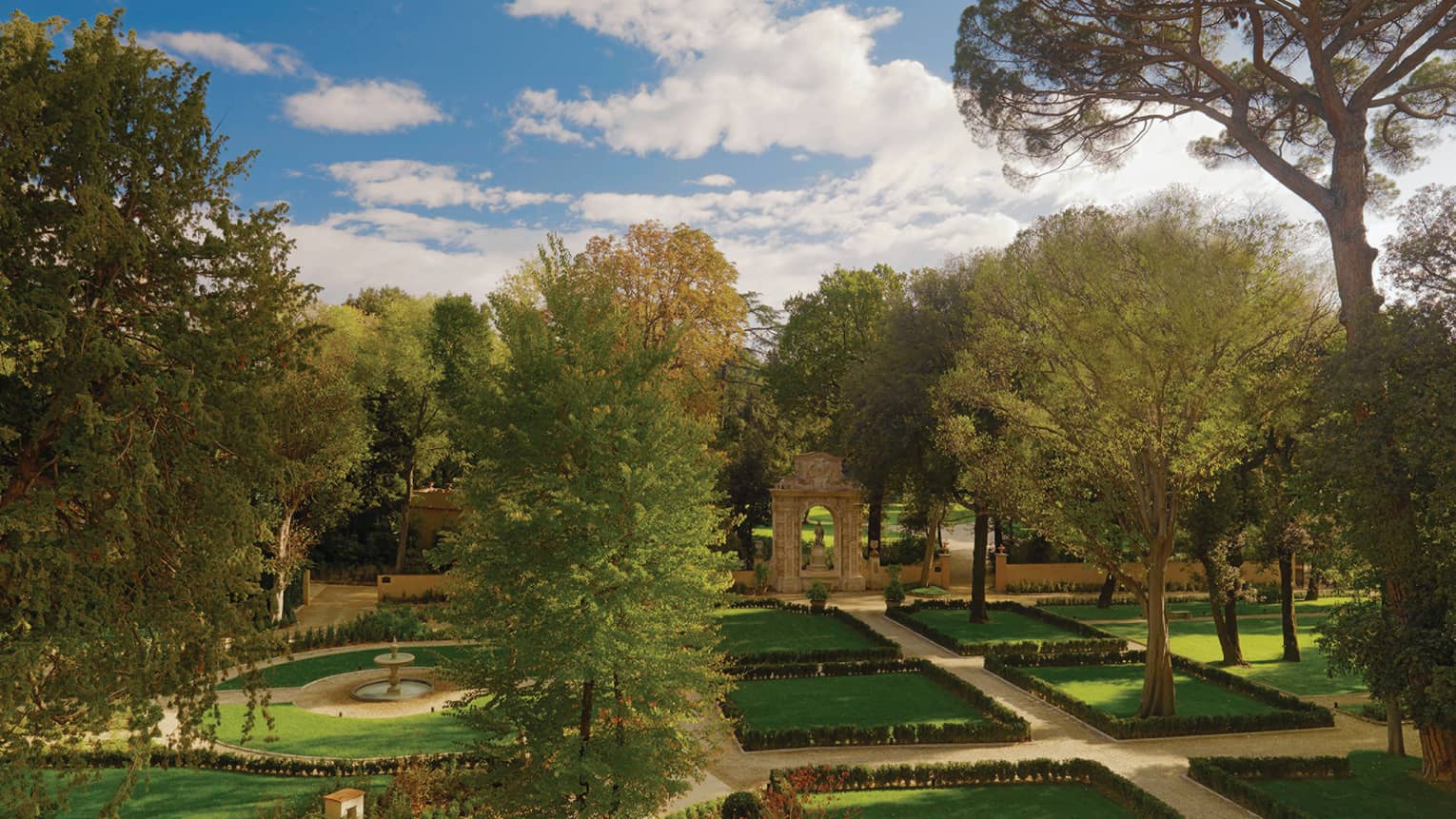 Looking out over green lawns, gardens, large tree, fountain