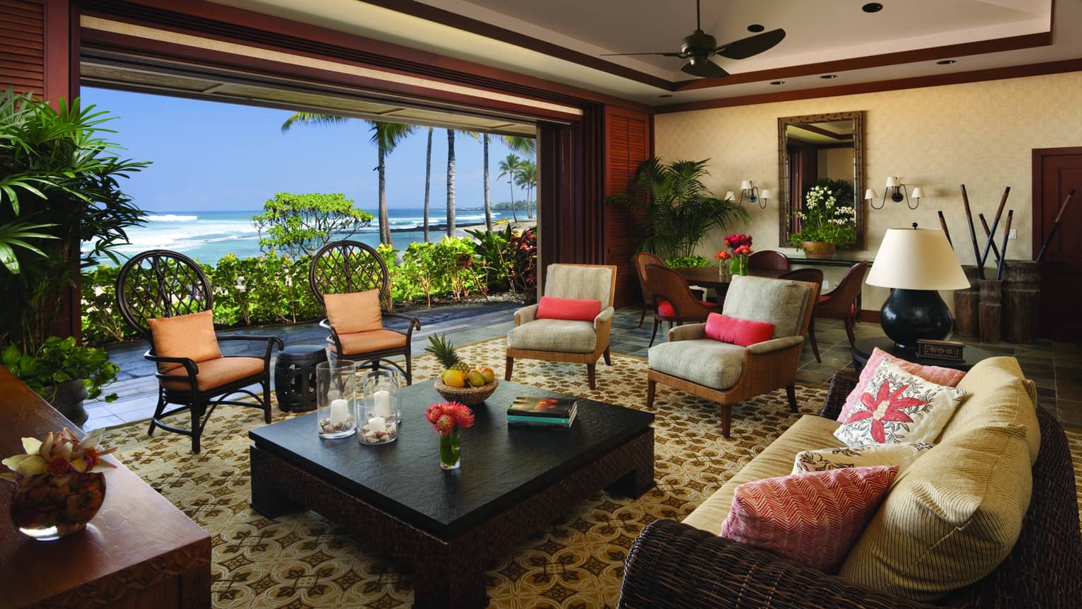 Ho'onanea Villa living room wicker sofa, cushioned chairs by open wall, ocean view