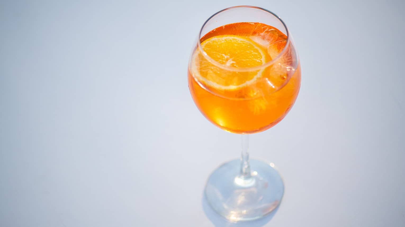 An orange aperol spritz in a crystal glass.