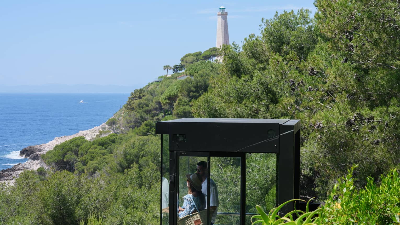 A couple admiring the sea view from the glass funicular at Club Dauphin