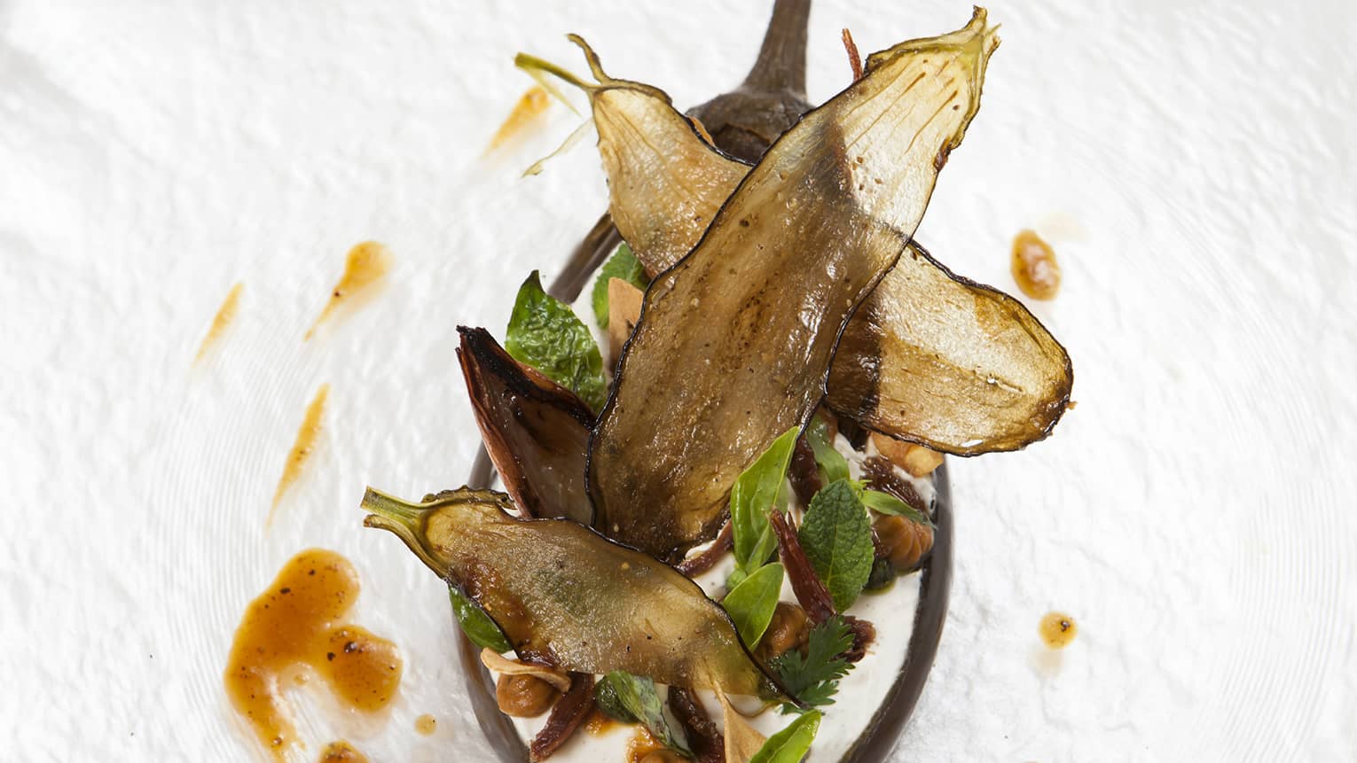 The Eggplant Signature Dish, served with basil and a creamy sauce