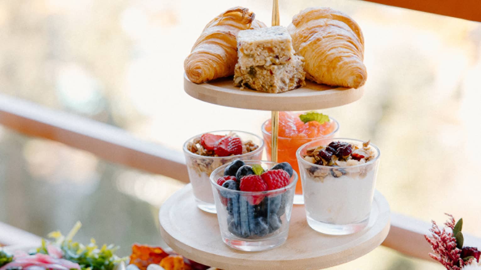 Three-tier tower with breakfast spread on outdoor table