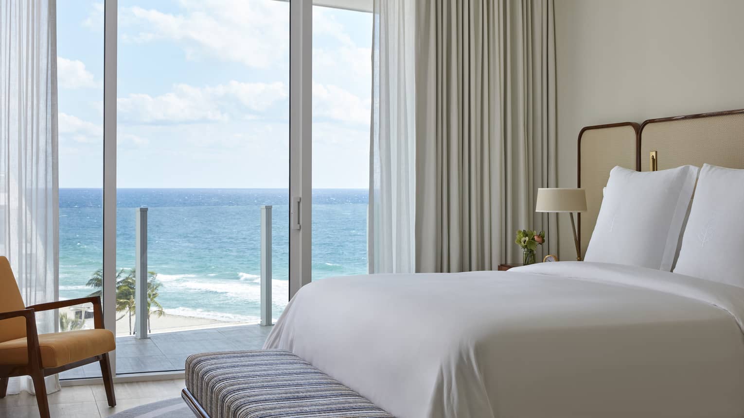 Bedroom with king bed and ocean-view balcony